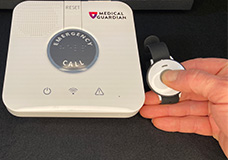 Medical Guardian Classic with hand pressing button