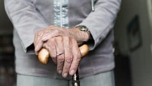 seniors hand, elderly holding a cane