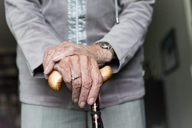 seniors hand, elderly holding a cane