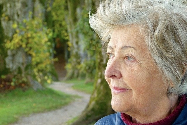 senior woman with trees in background